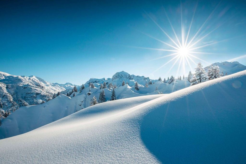 Światło słoneczne nad błyszczącymi stertami śniegu