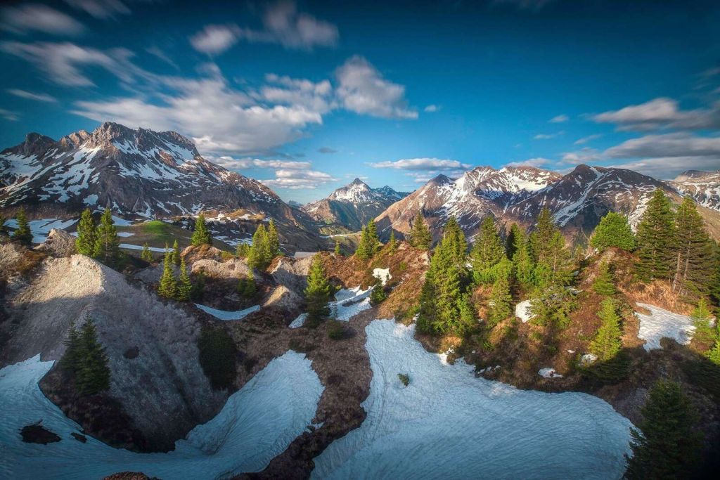 Lentezon nad zasnieżonym lasem górskim